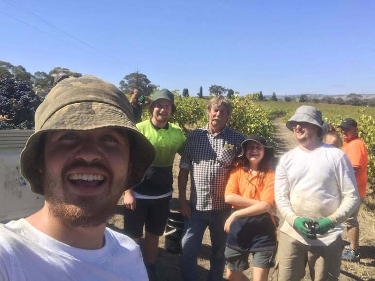 Group of backpackers posing happily with Australian post bikes